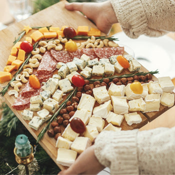a charcuterie board with a chirstmas tree shaped spread