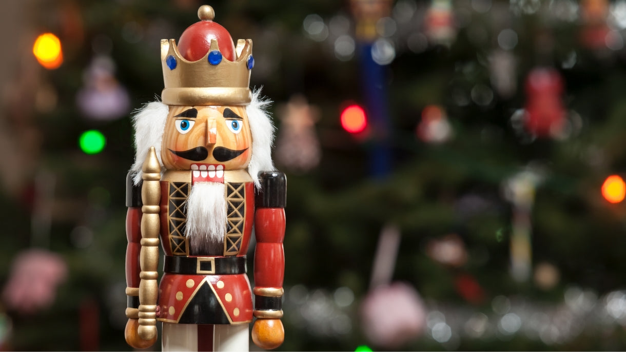 vintage nutcracker in front of a chirstmas tree