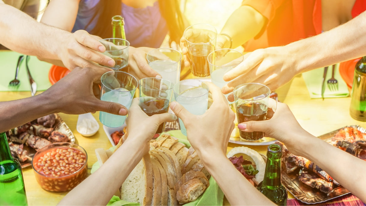 arial shot of a group of people toasting over a BBQ spread